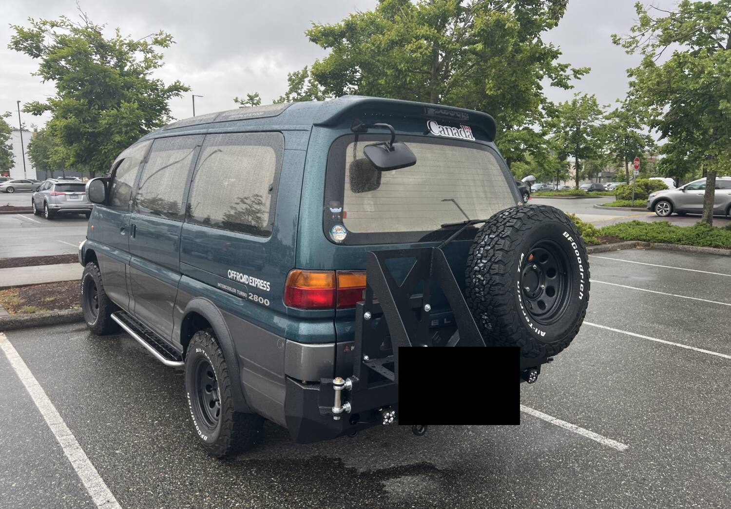 Rear view of the Delica showing the spare tire carrier and roof rack